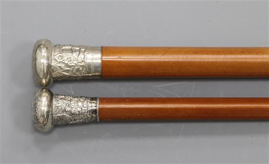 Two late 19th / early 20th century Chinese silver knopped malacca canes, 33in. and 35in.